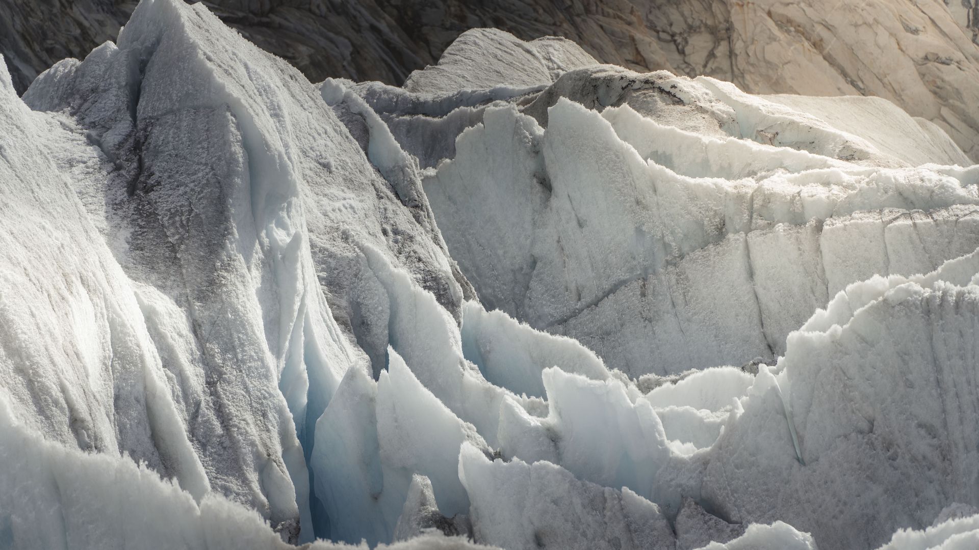 Detailed view of deep crevasses and white ice formations that can be seen on the Aletsch Arena glacier tour.